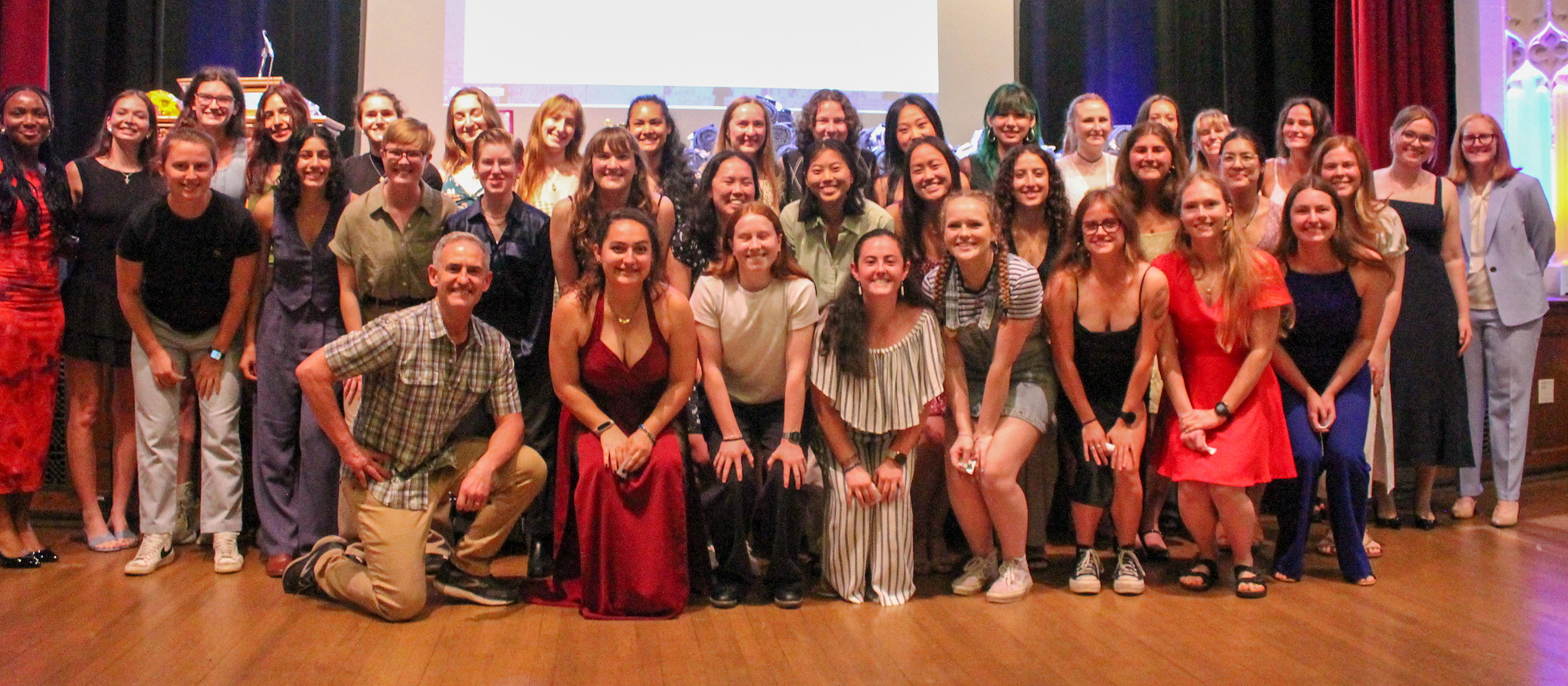 Mount Holyoke's 2024-25 Scholar-Athletes pose for a photo with faculty athletics representative Craig Woodard and director of athletics Andrea Ricketts-Preston during the annual awards celebration on May 4, 2025. (Alex Dizes)