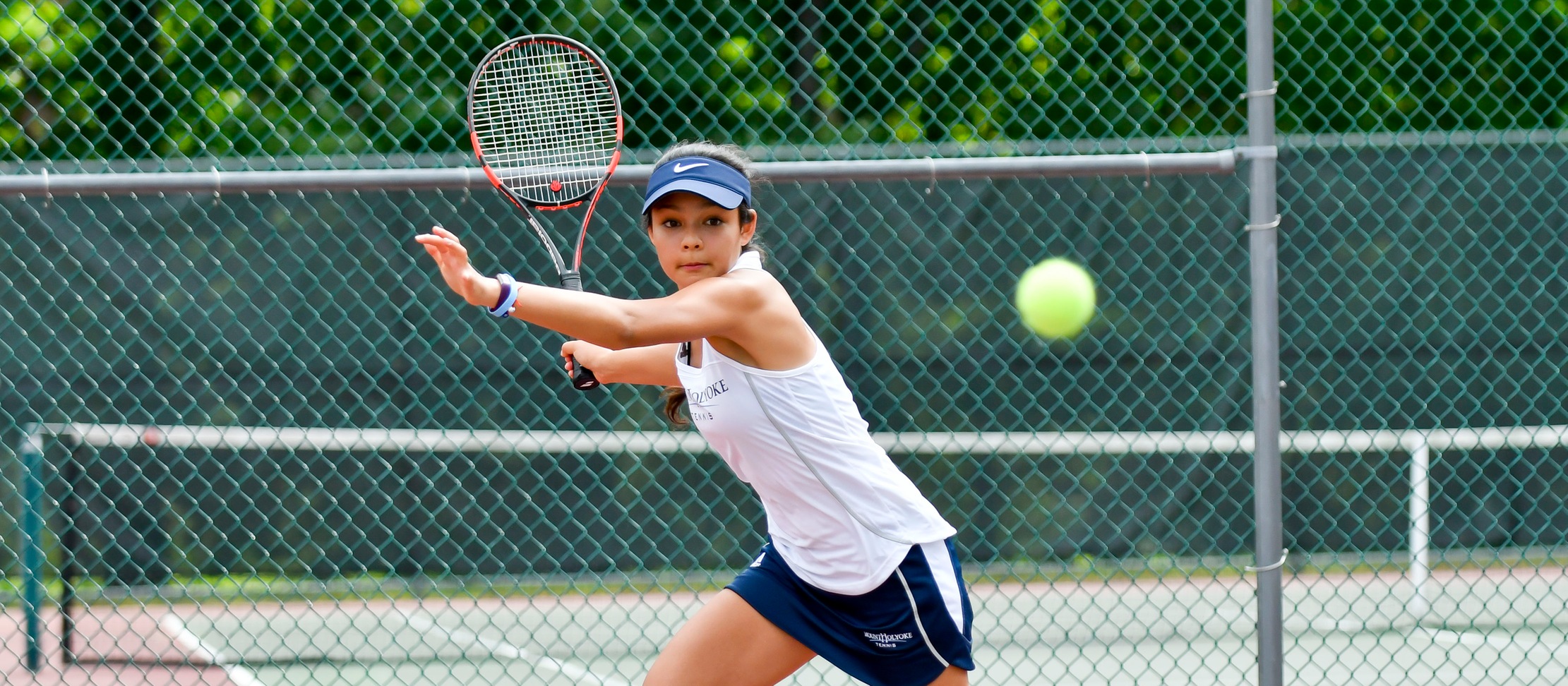 Action photo of tennis sophomore Catherine Peabody.