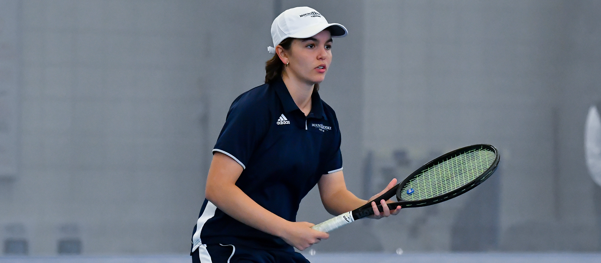 Action photo of Lyons tennis player, Annissa Aamoum.