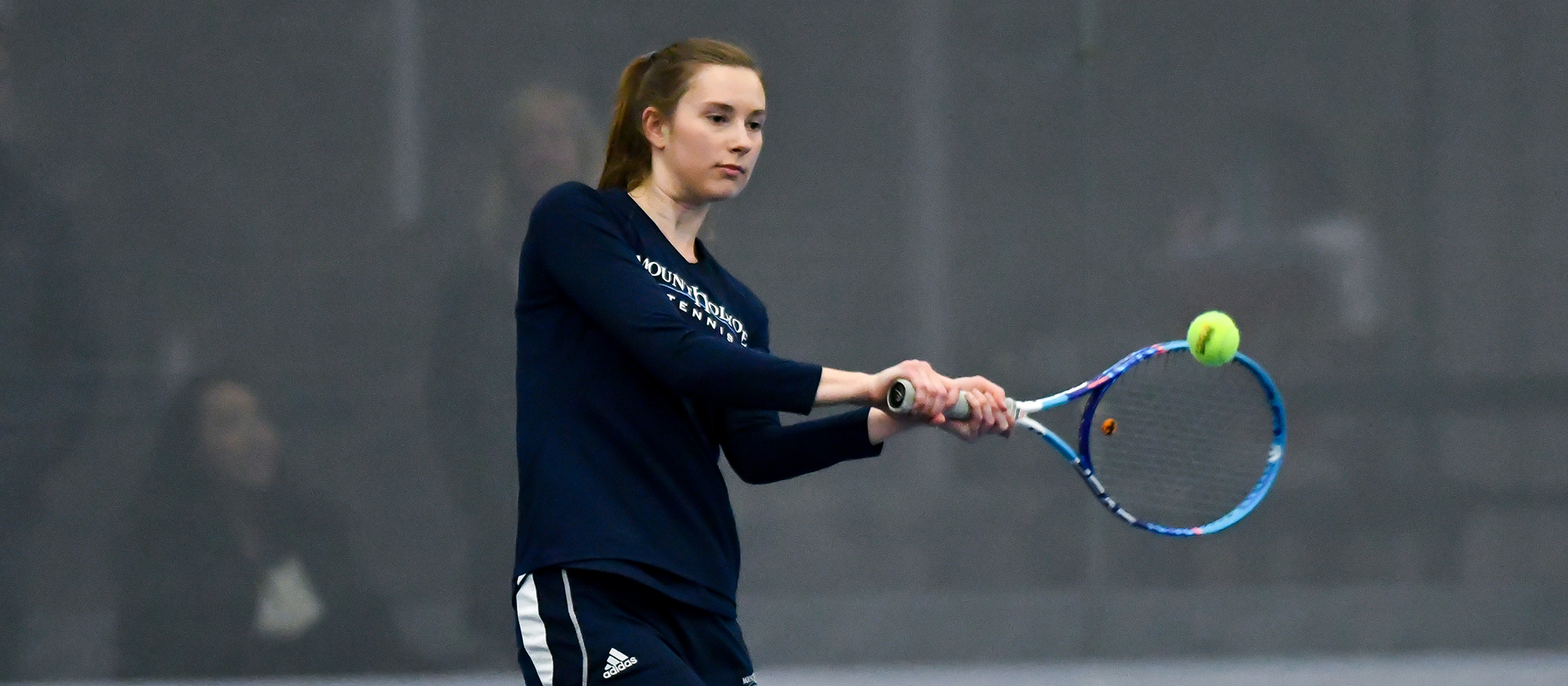 Action photo of Lyons tennis player, Joy Maran.