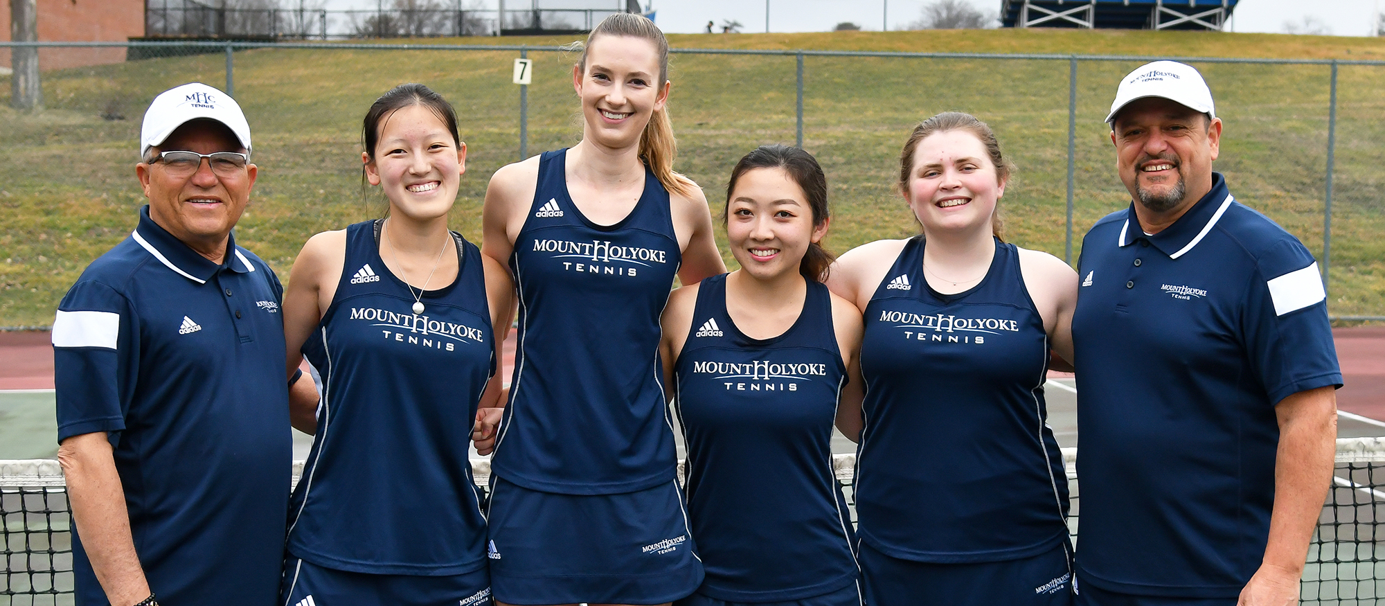 Group photo featuring the Lyons Tennis team's four seniors, plus their coaches.