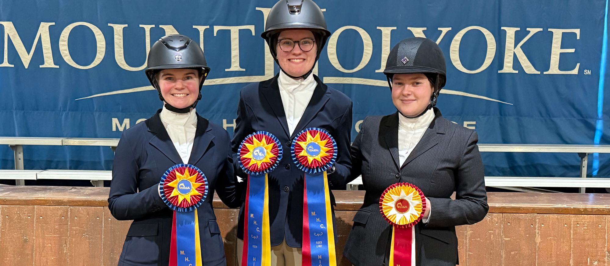 Left to right: Eliza Mutz (High Point Intermediate Champion), Bessie Huggins (High Point Rider and Limit Champion), and Nora Tripp (Limit Reserve Champion) after the Mount Holyoke Show on Nov. 15, 2025.