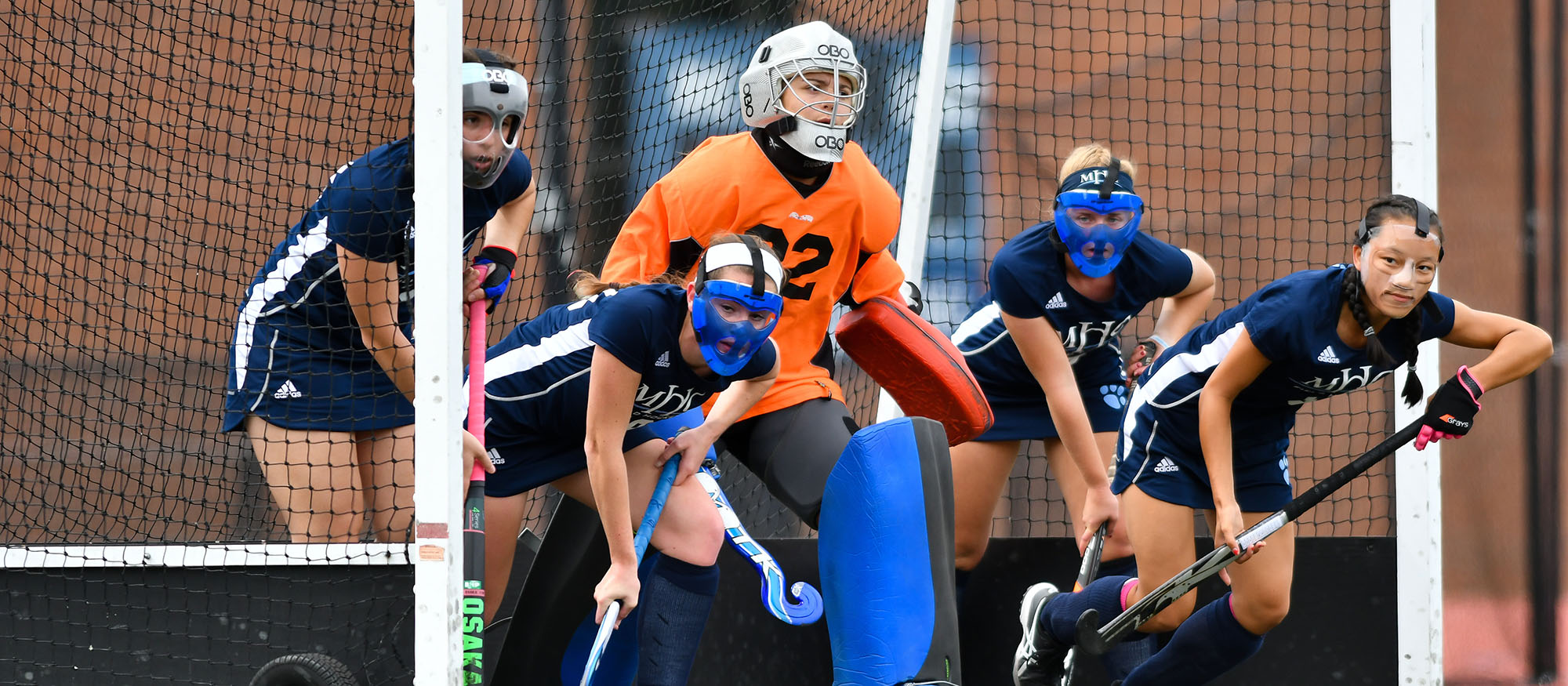 Action photo of the Lyons field hockey defense on a penalty corner.
