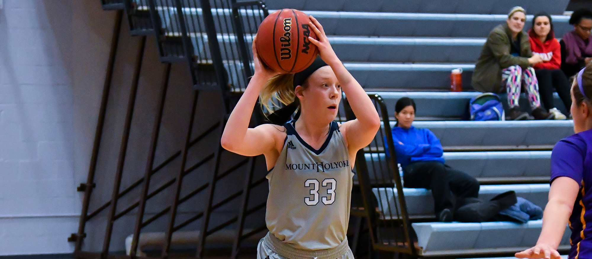 Action photo of Lyons basketball player, Michaela Butin.