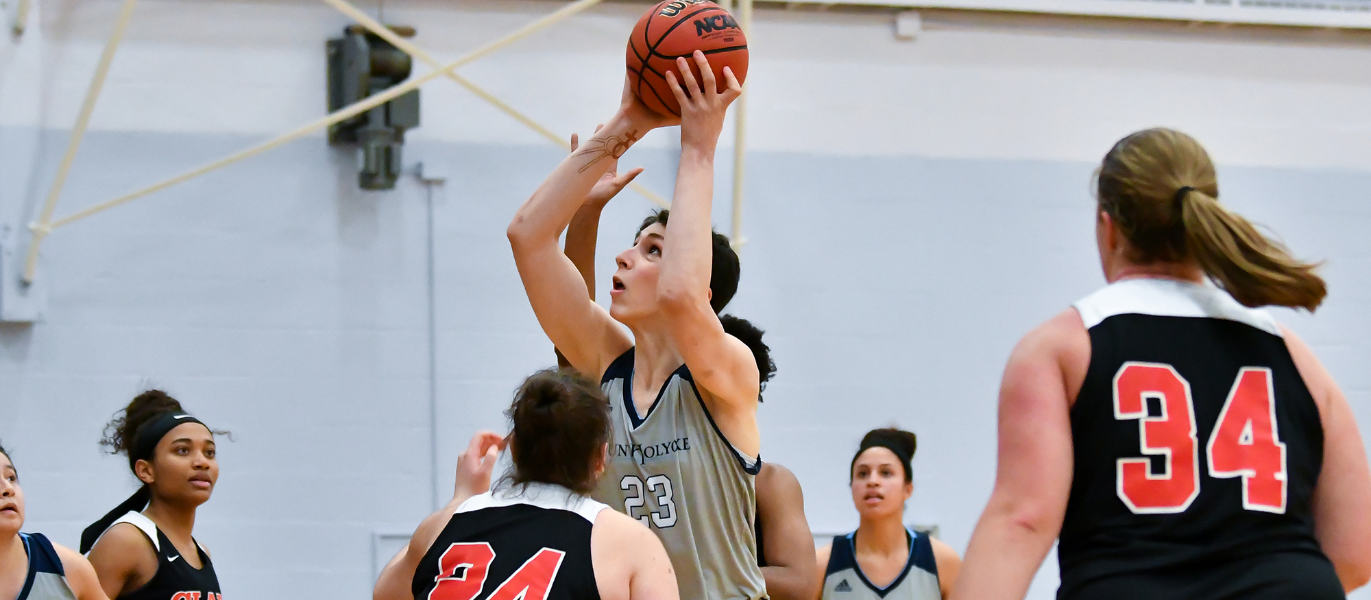 Action photo of Lyons basketball player, Julia Grey.
