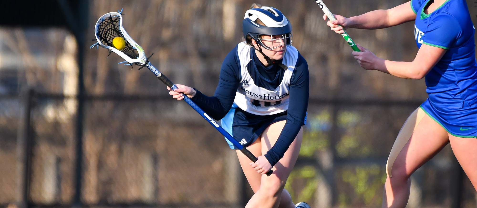 Action photo of Lyons lacrosse player, Chelsea Braz.