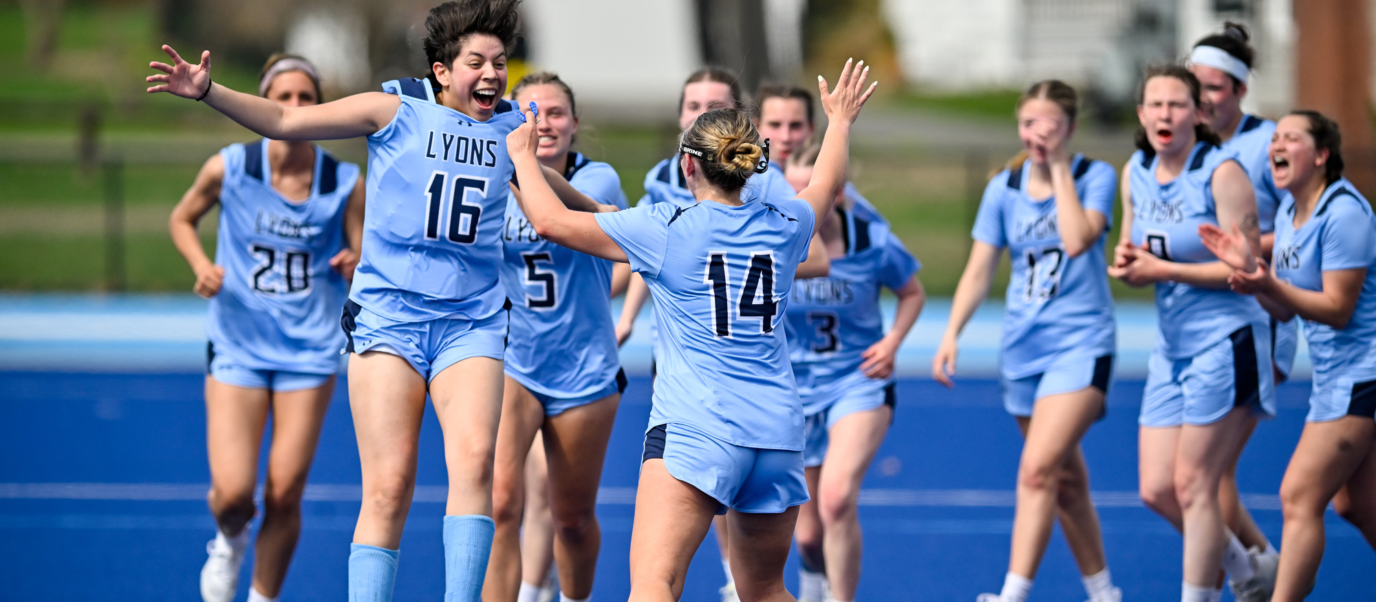 Mount Holyoke lacrosse celebrates its 12-11 victory over Wellesley College on April 19, 2025. (Bob Blanchard/RJB Sports)