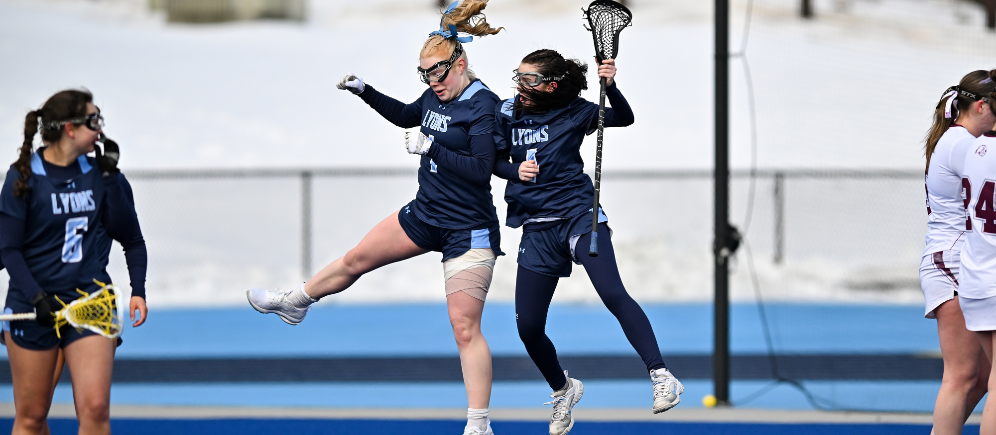 Grace Bird (left center) and Molly McSharry scored three goals and Molly McSharry (right center) scored four in Mount Holyoke's 23-5 win over Gordon on March 9, 2026. (RJB Sports file photo)