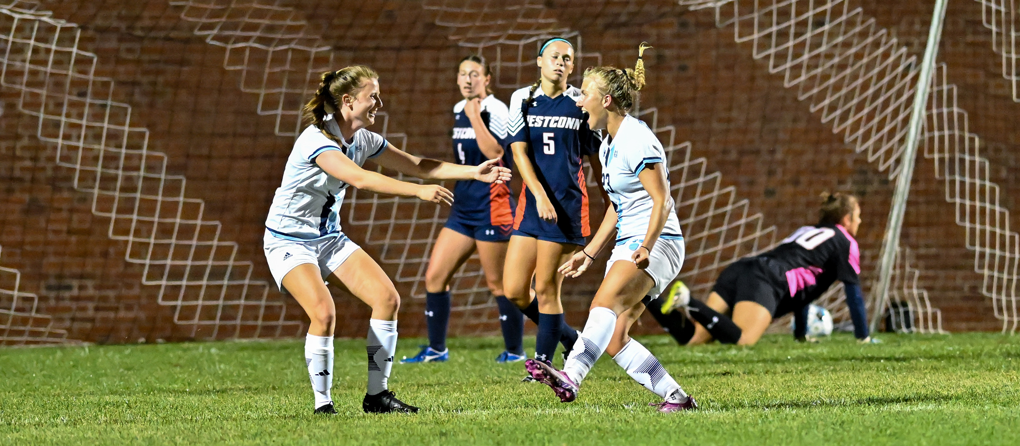 Ada Siepmann (right) reacts to her goal with teammate Hannah Keochakian in the 56th minute of Mount Holyoke's 1-0 victory over Western Connecticut State on Sept. 4, 2024. (Bob Blanchard/RJB Sports)
