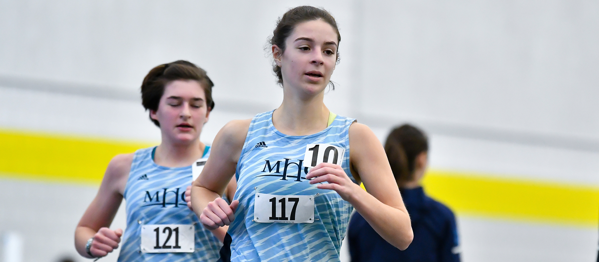 Action photo of Lyons track & field runner Emsie Cronin.