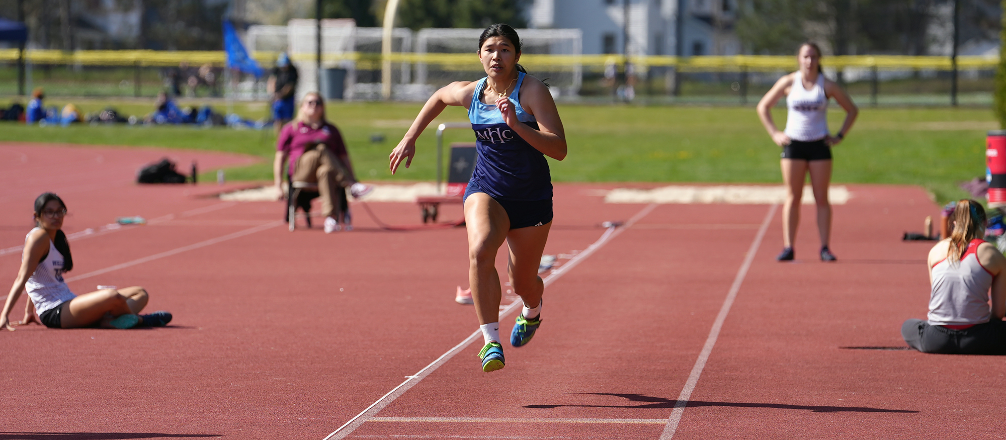 Elle Rimando sprints down the long jump runway on the first day of the NEWMAC Championships at Springfield College on April 26, 2024. Rimando placed fourth in the event. (Ben Barnhart/Courtesy Springfield College)